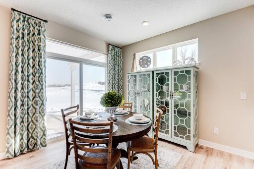 Informal dinette next to your sliding patio door and extra pianos windows, always included, allow for an inflow of sunlight! Model photo. Options and colors will vary in our available inventory homes.