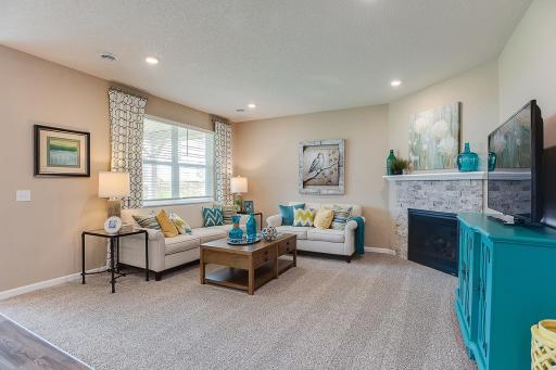 The home's family room is abundant in space and opens into the rest of the main level living areas. The corner gas fireplace makes the space feel extra cozy!