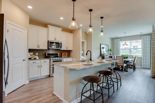 Thoughtfully designed kitchen with ample counter space and gas appliances. *Photo of model home, selections and colors to vary.