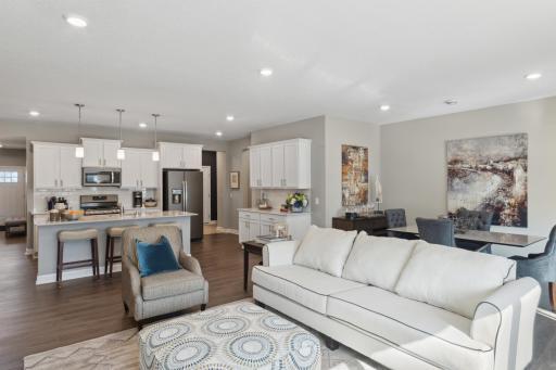 (Photo of completed model home, actual home's finishes vary) Gorgeous and durable luxury vinyl plank flooring runs through the main level.