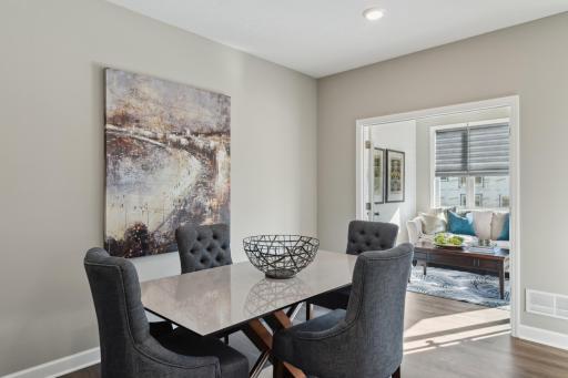 (Photo of completed model home, actual home's finishes vary) The dining area is nicely sized and is seamlessly connected to the kitchen, family room, and 4-season porch.