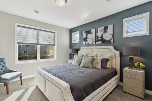 (Photo of completed model home, actual home's finishes vary) The private primary bedroom is a tranquil haven for relaxation and includes an en suite bath and walk-in closet.