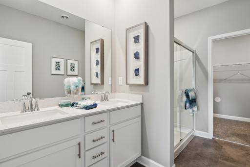 (Photo of completed model home, actual home's finishes vary) The luxurious en suite 3/4 bath includes a large double-sink vanity and great cabinet space for plenty of storage.