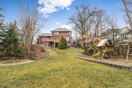 Lot is nearly a 1/2 acre - this is taken from the side boundary line so you can see the private backyard and the rainbow playset that stays with the home!