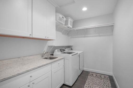 The second floor of this home has a laundry room with a washer and dryer. The laundry room is conveniently located near the bedrooms.