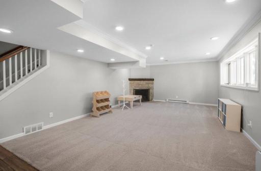This lower level walk-out room can be used for multiple purposes. It has a fireplace and opens to the front yard.