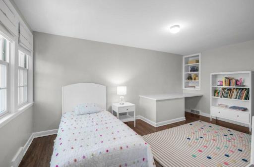 The fourth of four bedrooms on the second floor features a built-in desk and a walk-in closet.