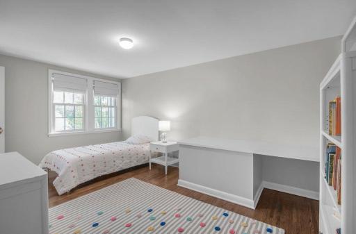 The fourth of four bedrooms on the second floor features a built-in desk and a walk-in closet.