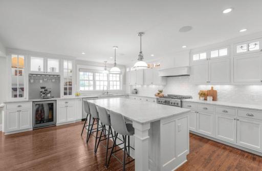 A favorite place for guests to gather featuring beverage refrigerator and a coffee station.