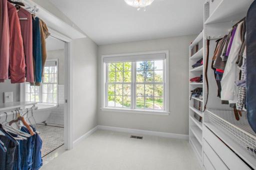 This is a bright, big closet with lots of storage space.