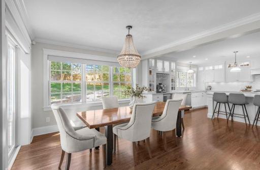 This dining room features classic hardwood flooring. The room is spacious and has an abundance of natural light. It would make an excellent venue for entertaining guests.