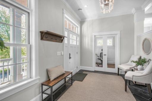 This bright foyer has pocket doors that lead to the office. This is a great space to work from home or just relax and enjoy the view.