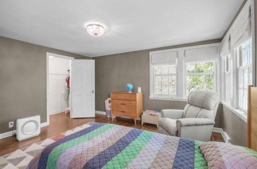 This is bedroom 3 of 4. It has hardwood floors and lots of windows, making it bright and airy.