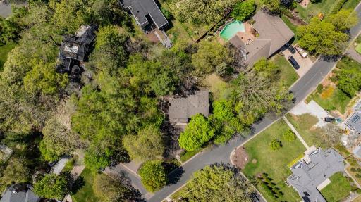 This expansive lot has mature trees which provides privacy and a picturesque setting.