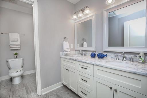 Full bathroom upstairs with large double vanity, separate shower and commode.