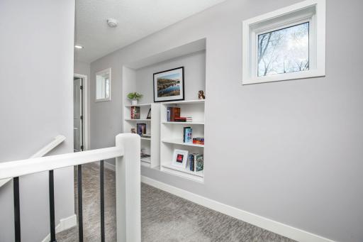 Upon entering the upper level- there is a nice landing with bookcases and a space to show off your art. Additional windows make the space feel bright and open.