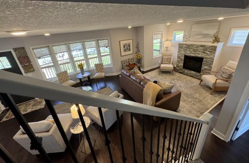View of the living room from the stairs- this spectacular room provides multiple places to relax and entertain.
