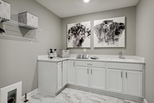 (Photos of model home, finishes will vary) Conveniently located on the second level, this plan features upper-level laundry right next to the home's four bedrooms.
