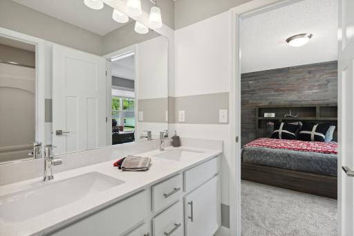 (Photos of model home, finishes will vary) The convenient, well-designed dual entry bathroom features a double-vanity with separate shower/tub area, offering two private spaces.