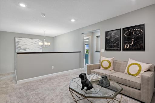 (Photos of model home, finishes will vary) Located on the upper level, this perfectly sized loft has room for a television and seating for all. Plus, it is just steps away from all 4 bedrooms.
