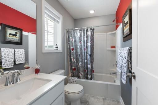 Upper level full bathroom shared between bedrooms #2 & #3. (Photo of decorated model, actual home's finishes may vary slightly)floorplan)