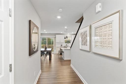 (Photo of decorated model, actual home's finishes will vary) Enter your new home! Front door/guest entry and garage entry with foyer area, coat closet, and half-bath powder room for the main level of the home.
