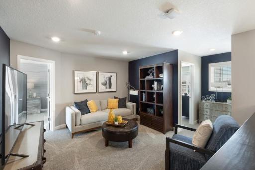 (Photo of decorated model, actual home's finishes will vary) Located on the upper level, this perfectly sized living space has enough room for a desk, television and seating for all. Plus, it is just steps away from the upper level bedrooms.