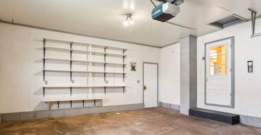 2 car attached garage with shelving for storage