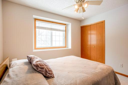 2nd upper-level bedroom with spacious closet and ceiling fan.