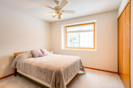 2nd upper-level bedroom with spacious closet and ceiling fan.