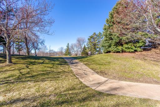 Nestled on one of the best lots in the highly-desirable Elm Creek development, this premium end-unit townhome features an adjacent green space surrounded by mature trees and has convenient access to walking paths.