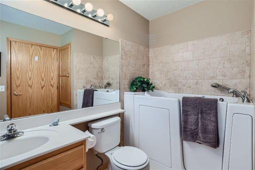 The walk-in tub is a wonderful convenience and the tile wall and floor is an added benefit