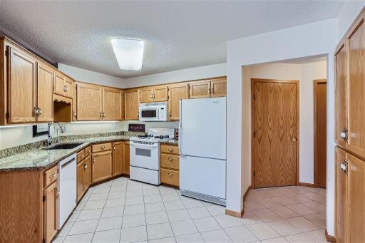 The kitchen provides ample storage and features a tile floor