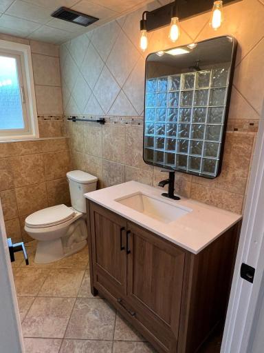 LL tiled bathroom with glass block walk-in shower with rainfall showerhead