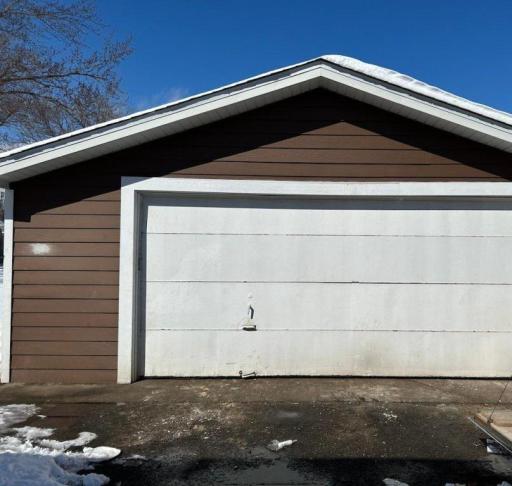 Garage door can be replaced if buyer requests. Extra large 2+ car garage features an overhead door in the backyard also