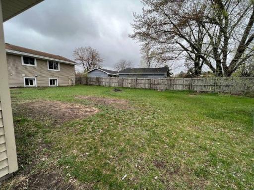 Large yard with privacy fencing and 2 sheds
