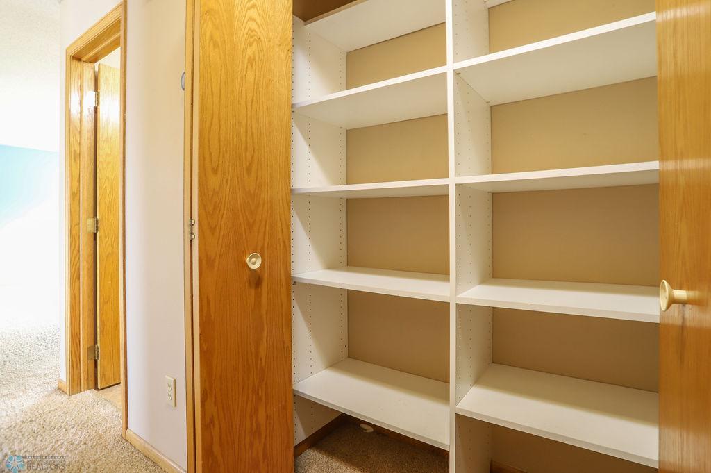 Pantry closet in hallway by kitchen