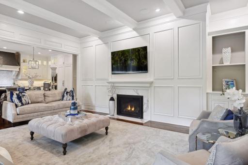 Crafted with attention to detail, this space boasts built-ins, ceiling beams, gas fireplace with hidden storage, and striking pillars and accents, creating a warm and inviting atmosphere.