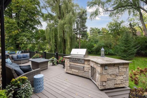 The deck itself boasts a Viking built-in grill and prep station overlooking the gorgeous backdrop of mature trees and fire pit for cozy autumn evenings.