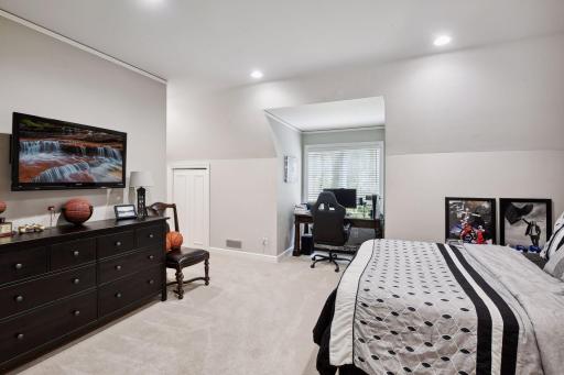 Across from the loft, the second upstairs bedroom awaits, offering a large walk-in closet with a professional storage system, as well as a second closet for added convenience.