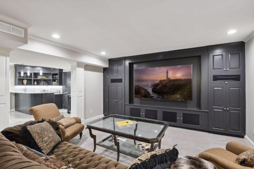 The family room boasts a large built-in entertainment center, ideal for movie nights.
