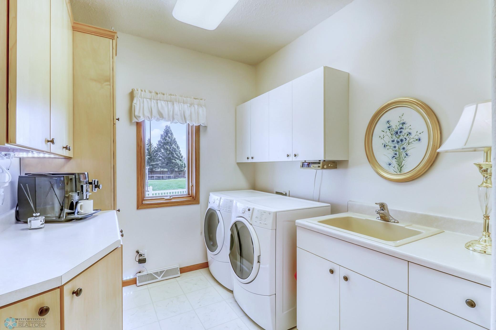 Main floor laundry-utility sink and cabinets galore