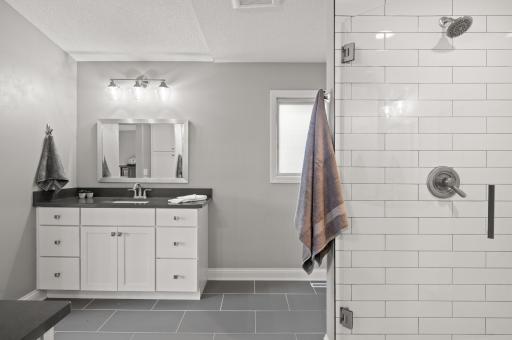 Clean and crisp space with so much room. Enjoy starting your day in this stunning bathroom.