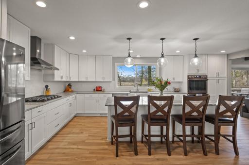 Enter into the stunning kitchen with granite counters and black stainless steel appliances.