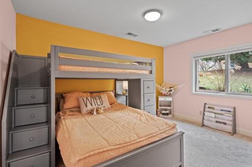 A lower level bedroom is spacious and inviting.