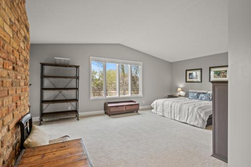 A very spacious main level primary bedroom provides room for large furniture as well as room for a sitting area.
