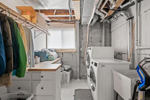 A large lower level laundry area provides additional storage and a folding/drying station. Add laundry appliances upstairs for the ultimate main level living!