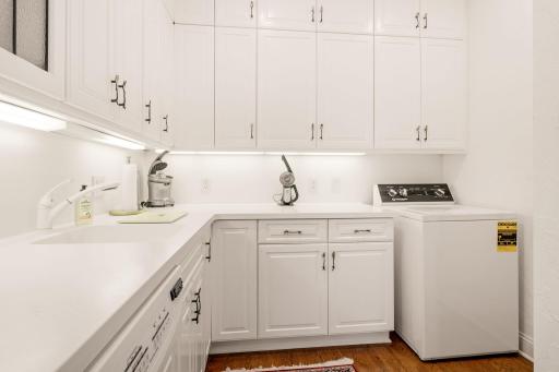 Butler's pantry room has another set of cabinetry, as well as main floor laundry!
