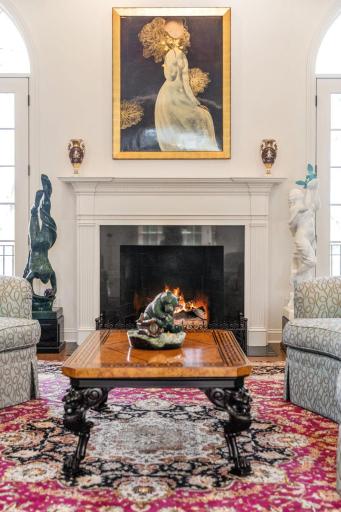 Gas fireplace has elegant detail in the mantel and surround.