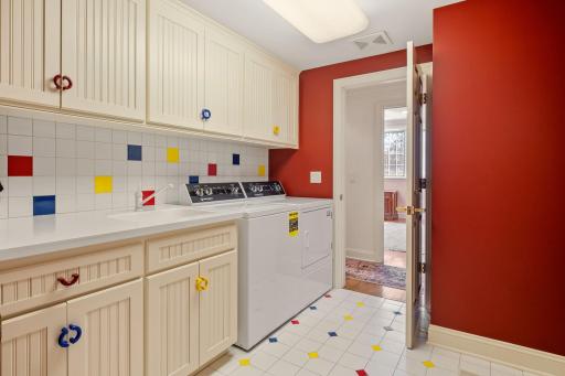Lower level laundry room with tons of storage and countertop space.